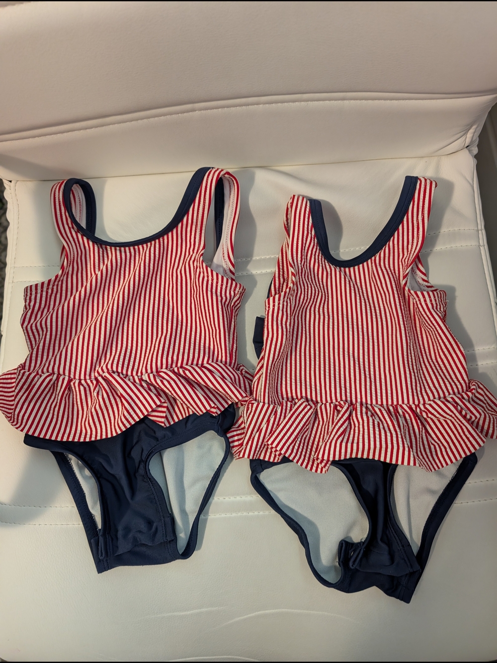 Matching Cat & Jack Red and Navy Striped Ruffle One-Piece Swimsuits.